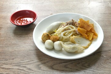 dry boiled meatball made from fish and shrimp with dumpling couple bean sprout ion plate dipping spicy and sour sauce