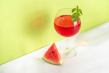 Homemade sweet cold watermelon wine glass with slices of ripe fresh red watermelon and mint leaves