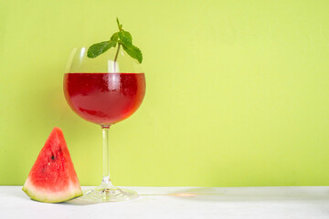 Homemade sweet cold watermelon wine glass with slices of ripe fresh red watermelon and mint leaves