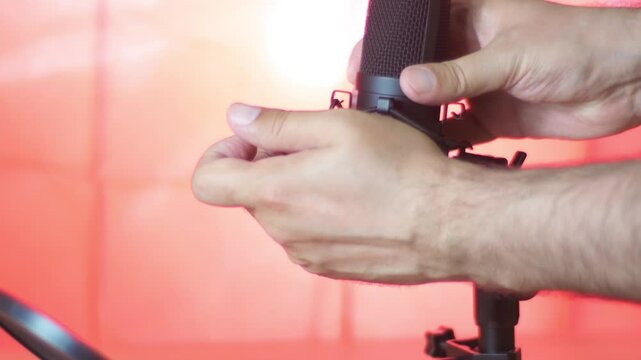 An audio technician installs and connects a professional microphone on radio. Connecting the cable to the socket.