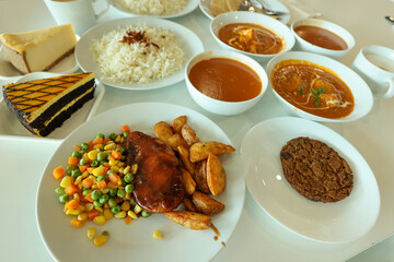Indian lunch different food mixed served on table. Butter chicken basmati rice paneer curry chicken breast chapati soup and cake served in India