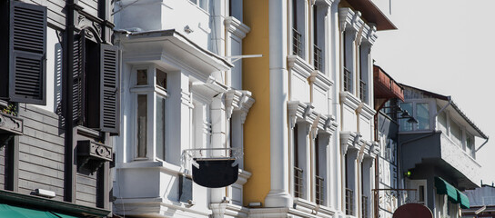 a contrast of old and new architecture with traditional wooden shutters on a historic building...