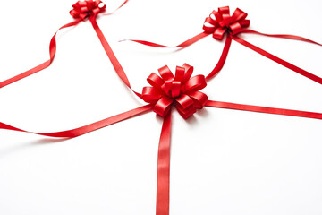 Red ribbons and bows on a white background