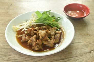 braised pork and fresh vegetable in herb brown soup on dish dipping spicy chili sauce 