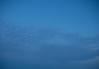 High stationary clouds and lower clouds, moving across the night sky,