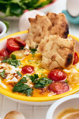 Cilbir or Turkish Eggs in white bowl. Turkish cuisine concept.