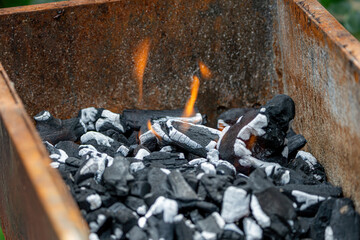 Burning coals in the grill for cooking fried meat on an open fire on a barbecue.