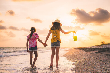 sunset stroll down Sanibel Island beaches with their shell bucket and a golden hour beach walk