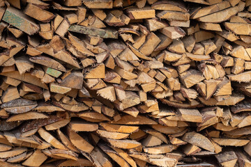 A pile of wooden boards and sticks all over the background. Sawed boards. Carpentry workshop. Wooden background