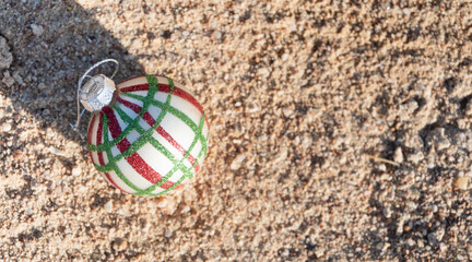 Christmas decorations bauble ball on sandy beach with sea background