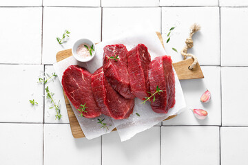 Beef. Raw beef tenderloin meat, beef steaks with ingredients for cooking. Top view