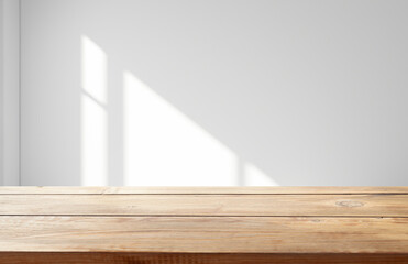 Shadow and light through a jalousie window on a tiled wall. Abstract shape of morning warm light and shadow on the wall..
