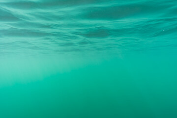 Underwater photo, texture, background, clear blue water at the Rummu quarry.
