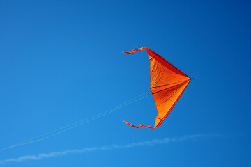 Kite flying high in a clear blue sky