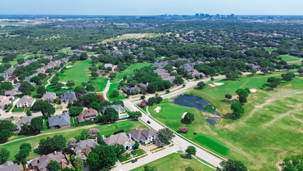 Upscale residential neighborhood urban sprawl lush greenery area with downtown Plano Texas in...