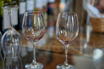 2 empty wine glasses on a table at a wine tasting in Cafayate, Argentina. Out of focus background
