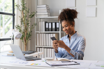 Female Entrepreneur. Cheerful African American Businesswoman Working On document and Laptop In Modern Office. Empty Space