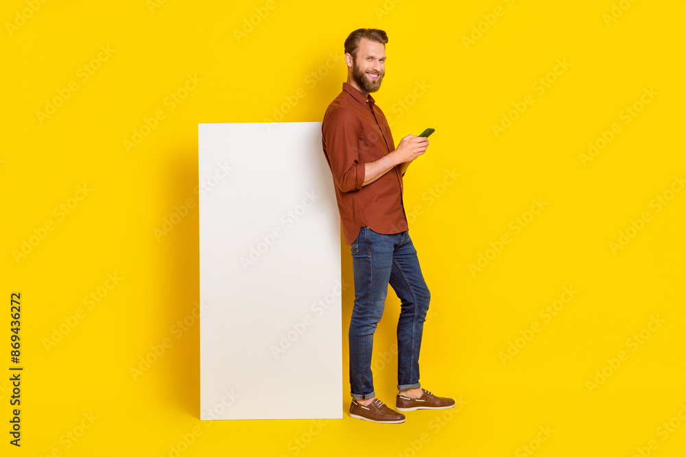 Aufkleber full length photo of handsome guy hold use telephone huge empty space display isolated on yellow col
