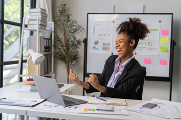 Female Entrepreneur. Cheerful African American Businesswoman Working On document and Laptop In Modern Office. Empty Space