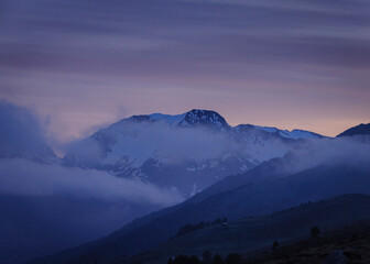 Sunrise towards the Tuc de Barlonguèra summit on a foggy spring morning (Aran Valley, Catalonia,...