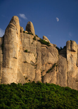 Montserrat north face and Moon seen from the Can Ma&ccedil;ana road to  monastery (Barcelona province, Catalonia, Spain)