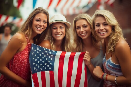 Brief Description:.Four smiling women hold an American flag at a festive event, with patriotic decorations in the background.