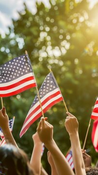 People holding American flags in a sunlit outdoor setting, possibly during a patriotic event or celebration.
