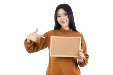 Asian young woman holding blank wooden frame and pointing at it isolated on white background with clipping path.