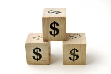 Four colorful blocks with dollar signs stacked together, representing financial concepts like investment, savings, and economic growth.