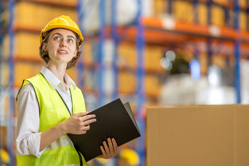 Female worker in warehouse, International import export , logistic business concept. Logistics, transportation, distribution concept. Team of factory workers working in logistic warehouse.