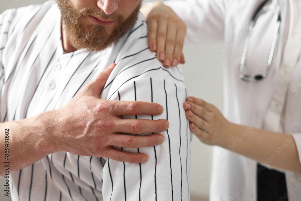 Canvas Prints Sports injury. Doctor examining patient's shoulder in hospital, closeup