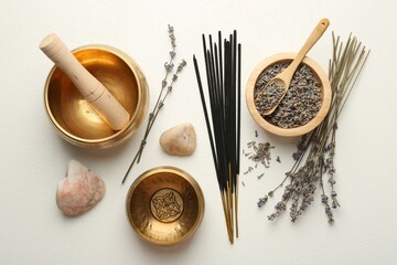 Incense sticks, Tibetan singing bowls, dry lavender flowers and stones on white table, flat lay