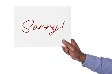 Man holding sheet of paper with word Sorry on white background, closeup