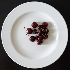 red currants on a white plate. 