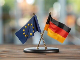 The flags of Germany and the European Union are on a wooden table