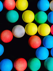 Top view of many colorful plastic balls on water. View of colored sponge balls. Many colorful balls as background. Lots of colorful balls for children to play in the water park. Toy pool for kids.