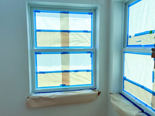 Windows Protected with Blue Tape and Paper During Home Renovation