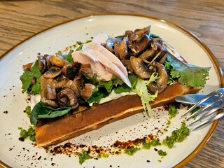 Belgian waffles with chicken fillet, mushrooms and arugula. Belgian food. View from above.