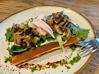 Belgian waffles with chicken fillet, mushrooms and arugula. Belgian food. View from above.