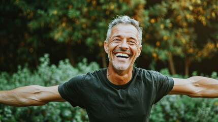 happy mature man with open arms enjoying life outdoors