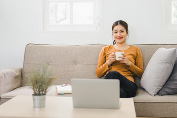 Happy asian young businesswoman calculate tax,counting paying domestic bills, e-banking,...