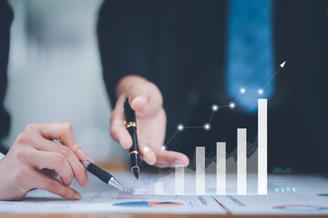 Close-up of business professionals analyzing and discussing data on growth chart, highlighting business performance and success. - Powered by Adobe