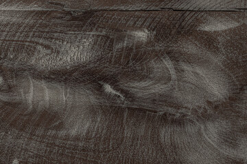 Wooden texture background. Close-up shot of a textured, brown wooden surface with white painted lines running across the grain.