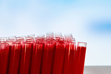 Laboratory test tubes with blood tests on a blue background