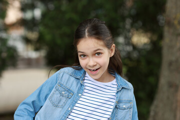 Portrait of happy little girl outdoors. Cute child