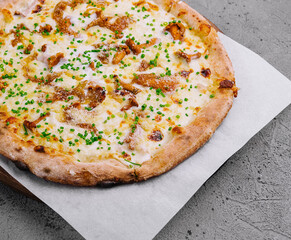 Freshly baked gourmet pizza on wooden board