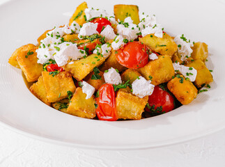 Fresh homemade polenta with tomatoes and feta