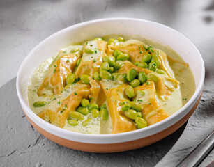 Fresh ravioli pasta with green pea sauce