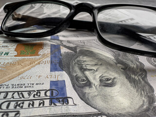 Wealth american one hundred dollar banknotes with glasses
