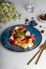 Crepes with Fresh Berries and Toppings, Rolled Thin Pancakes with Cottage Cheese Filling on a Plate